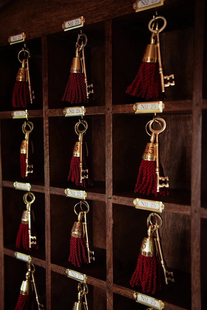 Santa's Magic Keys with red tassels hanging in wooden pigeonholes