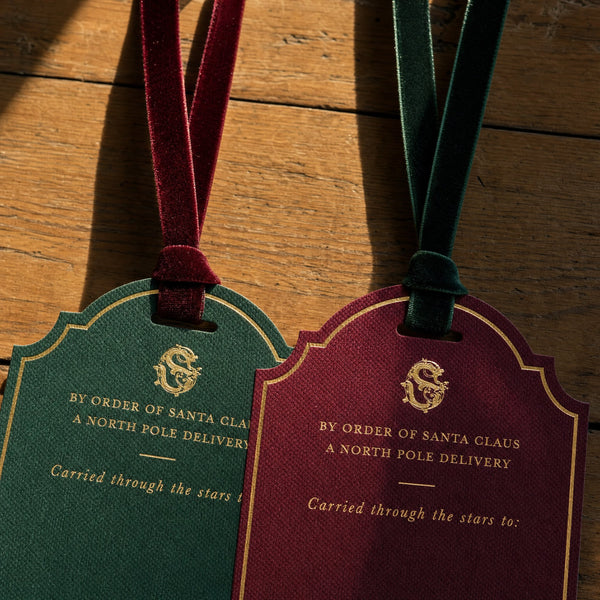 Large Personalised Christmas Gift Tag - The velvet ribbons knotted through the tops of two personalised Christmas gift tags